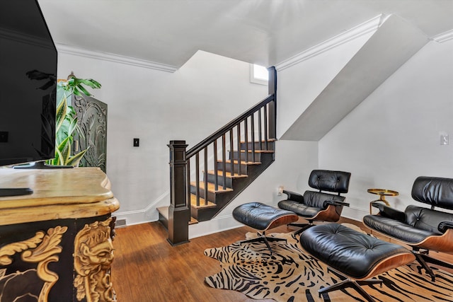 sitting room featuring wood-type flooring and crown molding