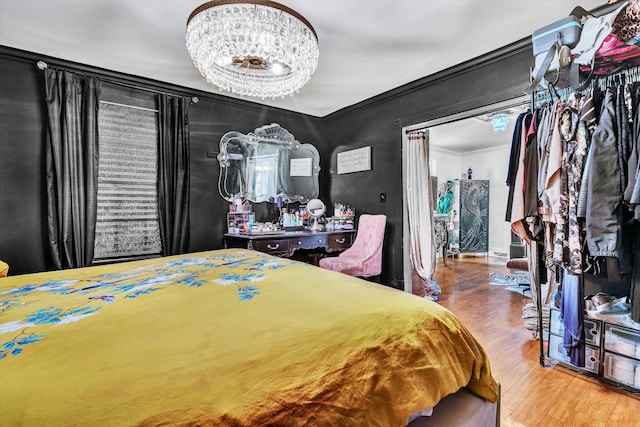 bedroom with ornamental molding and wood-type flooring