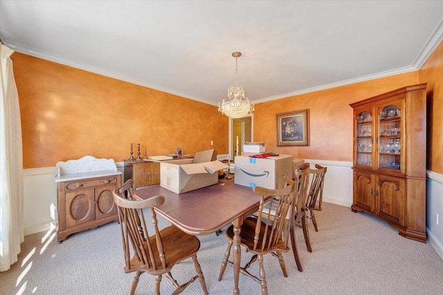 dining room featuring a notable chandelier, light colored carpet, and crown molding