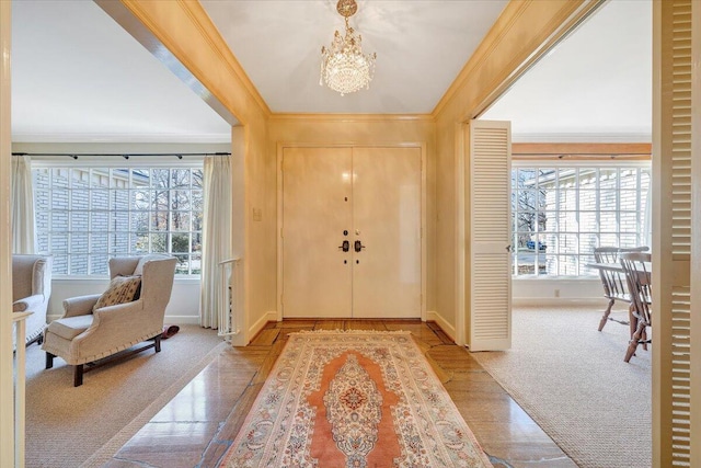 foyer entrance with light carpet, an inviting chandelier, and crown molding