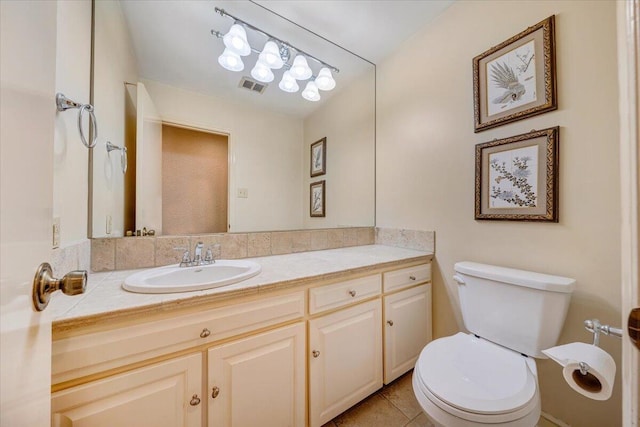 bathroom featuring tile patterned floors, vanity, and toilet