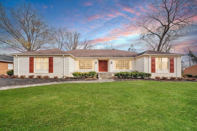 ranch-style house featuring a lawn