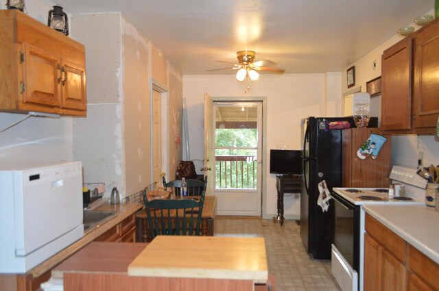 kitchen with a center island, ceiling fan, white range with electric cooktop, and wood counters