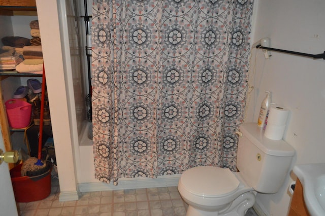 full bathroom featuring toilet and tile patterned floors