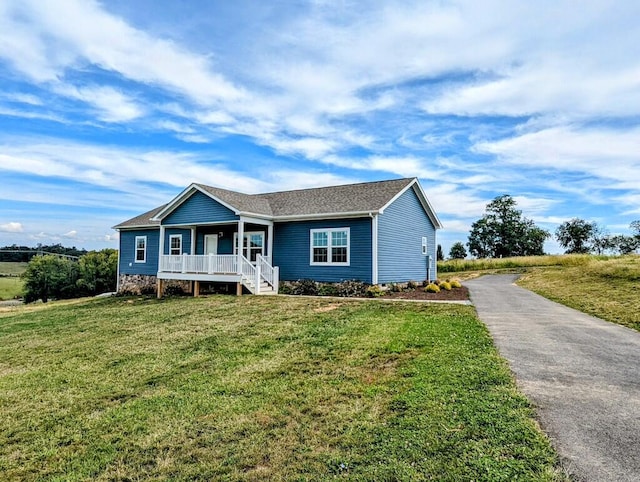 single story home featuring a front lawn and covered porch