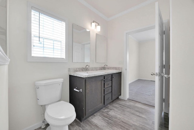 bathroom featuring vanity, toilet, ornamental molding, and hardwood / wood-style flooring