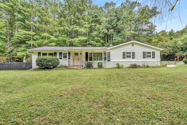 single story home with a front lawn and covered porch