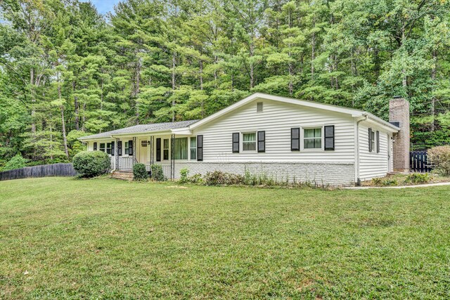 ranch-style house featuring a porch and a front lawn