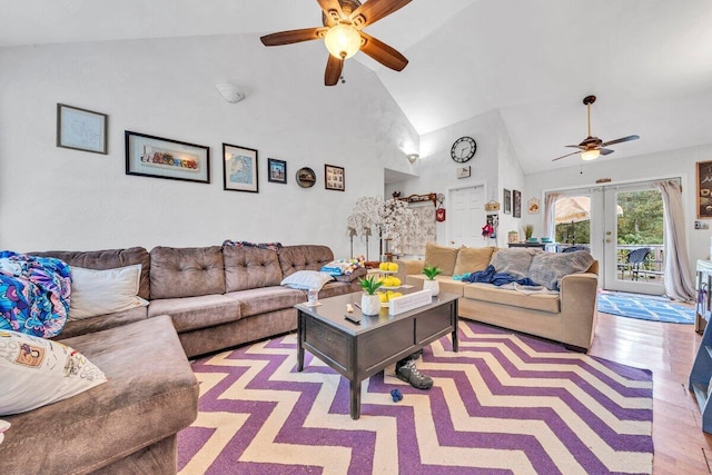 living room featuring high vaulted ceiling, ceiling fan, french doors, and light hardwood / wood-style floors