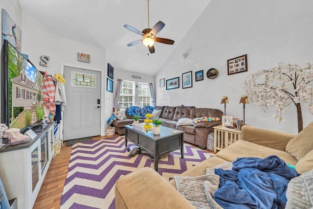 living room with high vaulted ceiling, ceiling fan, and light hardwood / wood-style floors