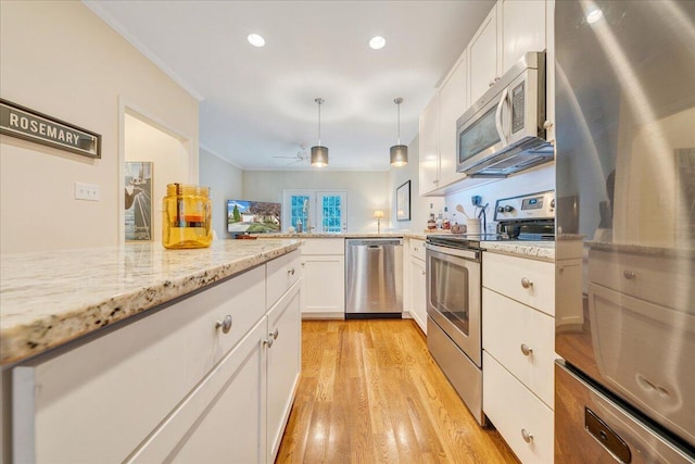 kitchen featuring light stone counters, ceiling fan, white cabinetry, stainless steel appliances, and light hardwood / wood-style floors