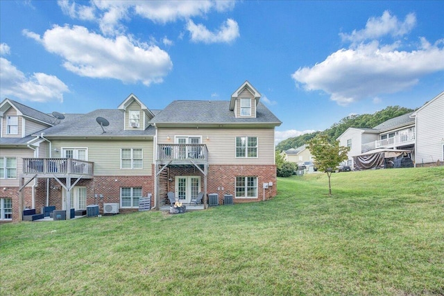 back of property featuring a wooden deck, a yard, and central air condition unit