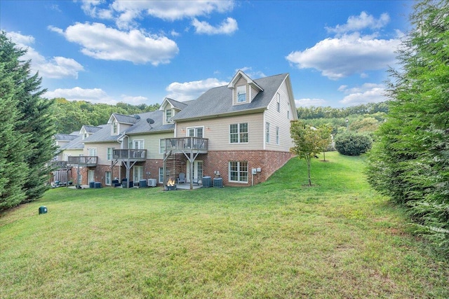 back of house featuring a yard and a wooden deck