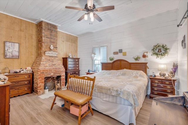 bedroom featuring wooden ceiling, wood walls, and light wood-type flooring