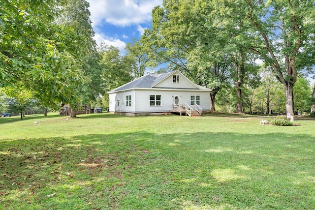 rear view of house with a yard