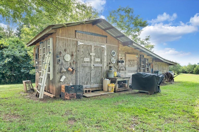 view of outdoor structure featuring a lawn