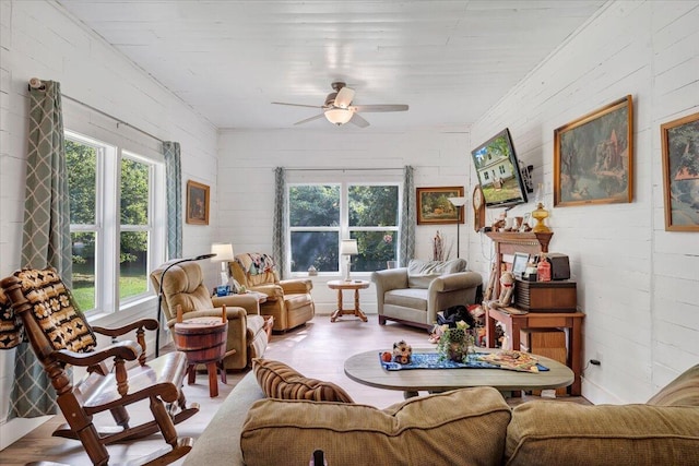 living room featuring ceiling fan and light hardwood / wood-style flooring