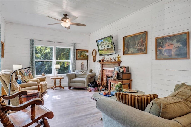 living room featuring light hardwood / wood-style floors and ceiling fan