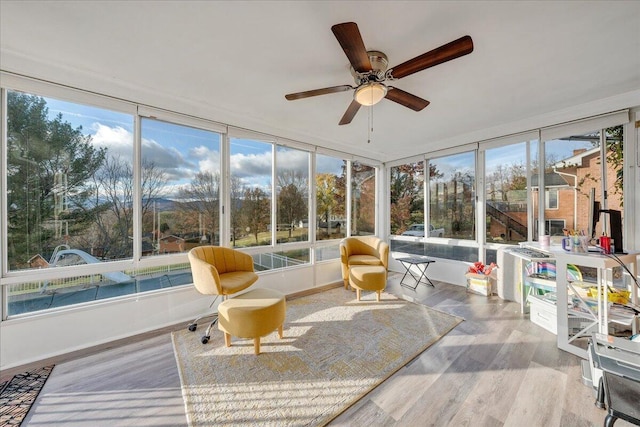 sunroom / solarium featuring ceiling fan and a healthy amount of sunlight