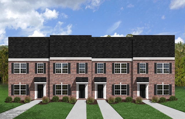 townhome / multi-family property featuring a front yard