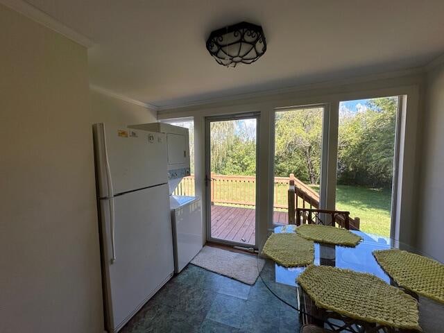 doorway to outside with ornamental molding and a healthy amount of sunlight