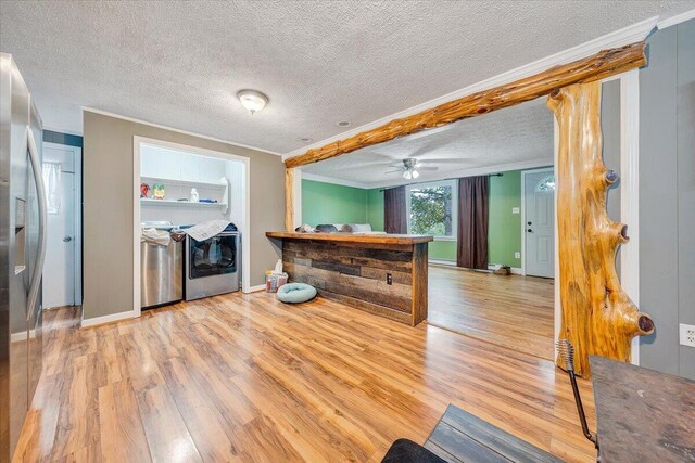 kitchen featuring a textured ceiling, wood-type flooring, crown molding, and ceiling fan