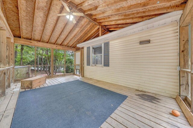 unfurnished sunroom with vaulted ceiling with beams and ceiling fan