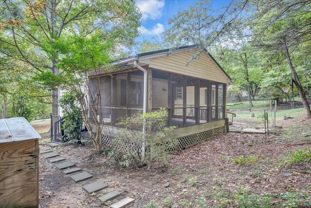 view of side of home with a sunroom