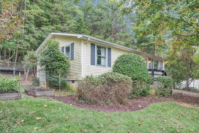 view of side of property with a lawn