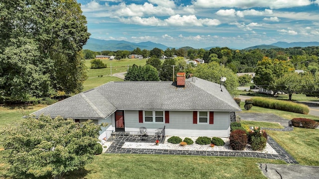 view of front of home featuring a mountain view and a front yard