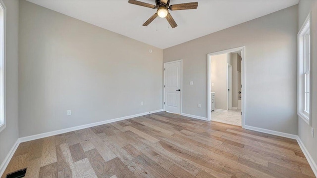 unfurnished bedroom featuring light wood-type flooring, visible vents, and baseboards