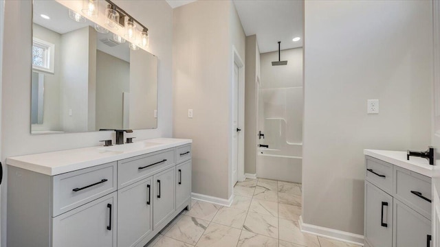 bathroom with marble finish floor, visible vents, a combined bath / shower with rainfall shower, vanity, and baseboards