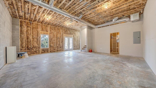 interior space featuring concrete floors, electric panel, and french doors