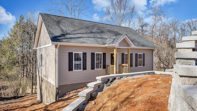 view of front of home with a shingled roof