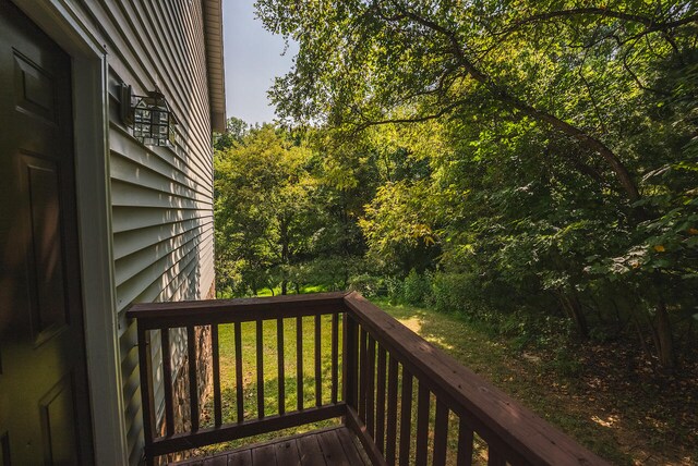 wooden deck with a lawn