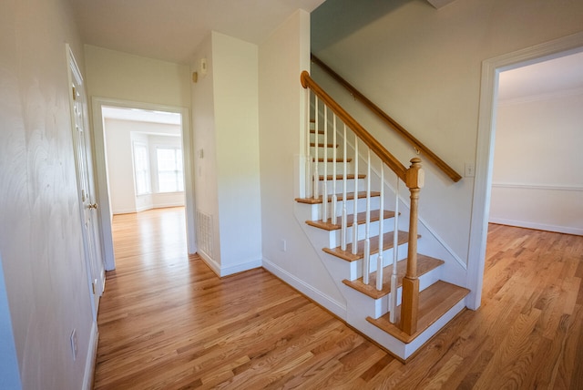 stairs featuring hardwood / wood-style floors