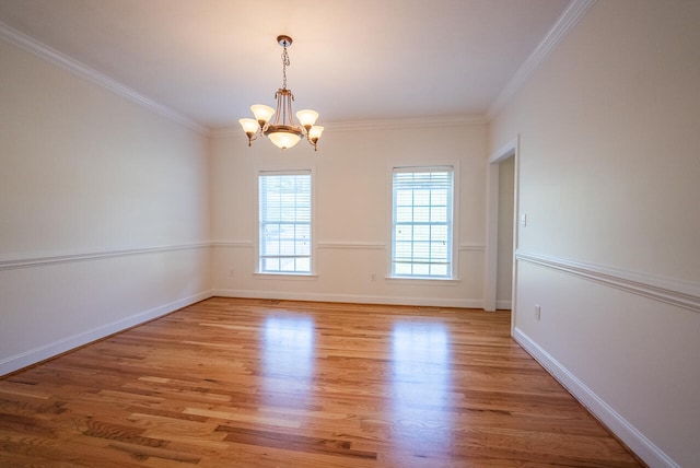 unfurnished room with light hardwood / wood-style floors, ornamental molding, and a chandelier