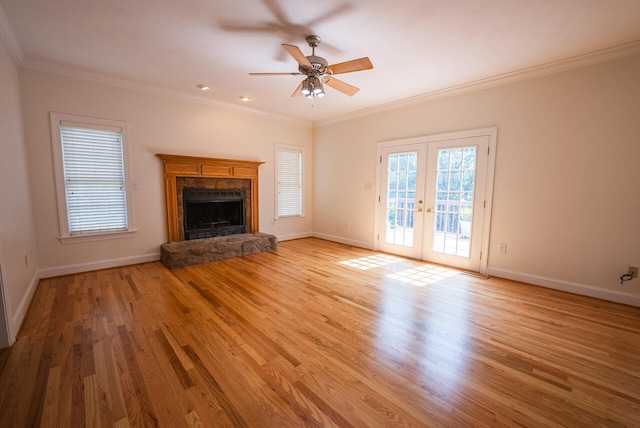 unfurnished living room with light wood-type flooring, a fireplace, ornamental molding, and ceiling fan