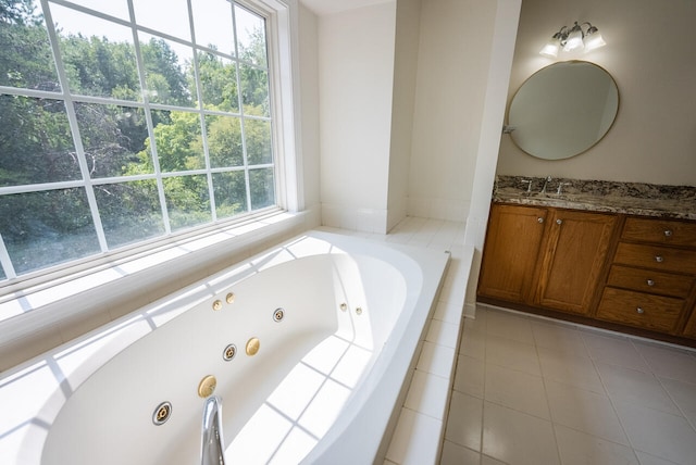 bathroom with tiled tub, vanity, and tile patterned floors