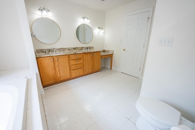 bathroom with a washtub, tile patterned flooring, vanity, and toilet