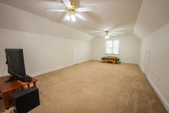 interior space with ceiling fan, light carpet, and vaulted ceiling