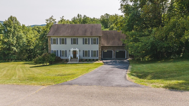 colonial inspired home featuring a front lawn