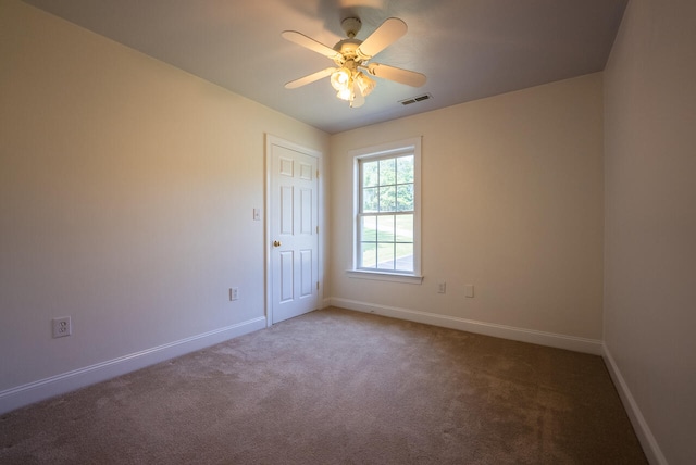 spare room with ceiling fan and carpet floors