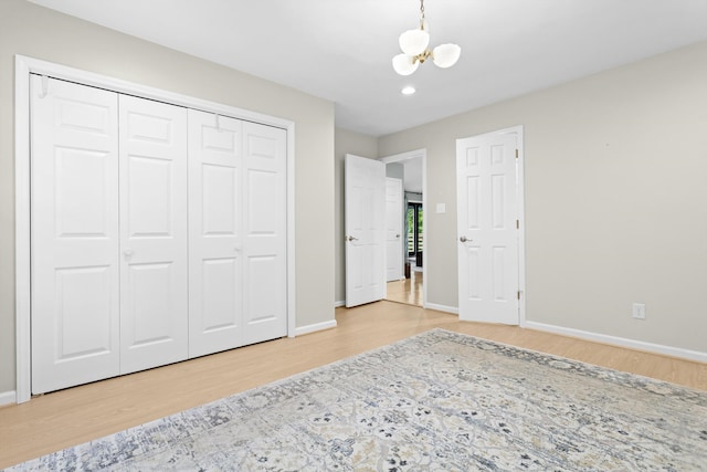 bedroom with a chandelier, a closet, and hardwood / wood-style flooring