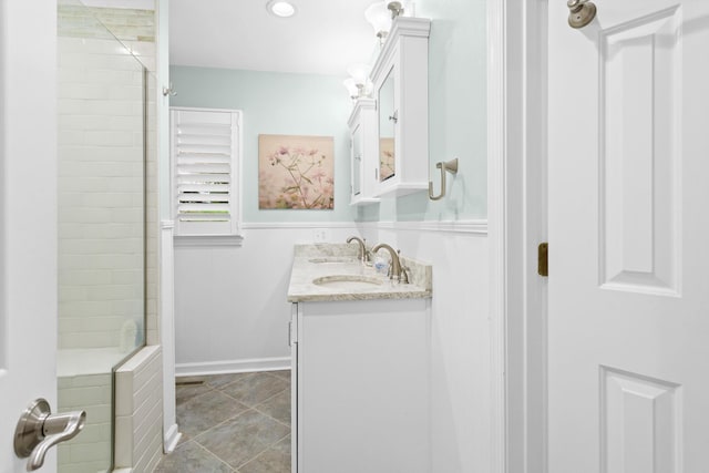 bathroom with walk in shower, vanity, and tile patterned floors