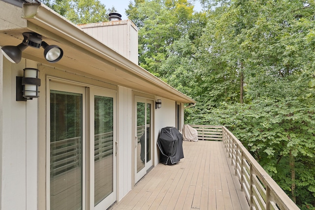 wooden terrace featuring a grill