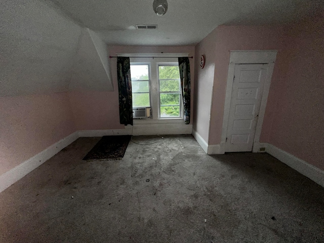 bonus room with light carpet, cooling unit, a textured ceiling, and vaulted ceiling