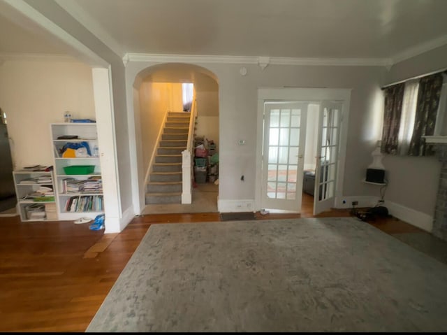 interior space featuring wood-type flooring and crown molding