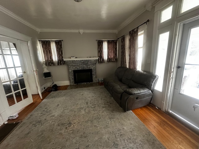 living room with crown molding, hardwood / wood-style floors, and a wealth of natural light