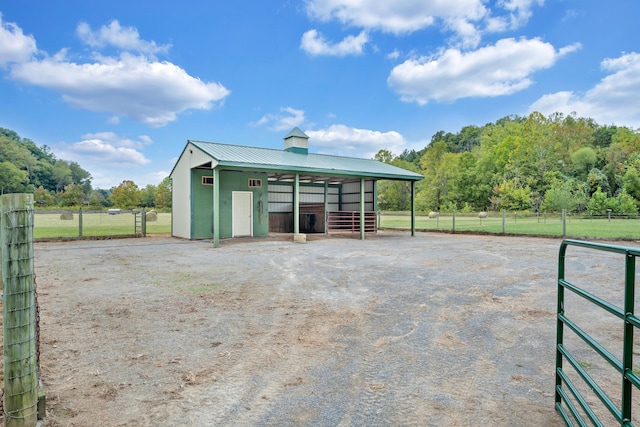 view of stable featuring a rural view